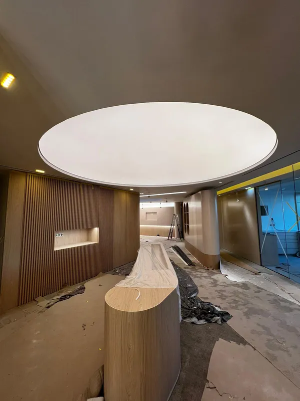 Round stretch ceiling under construction — commercial reception