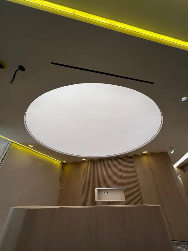 Stretch ceiling installation with yellow LED — commercial reception