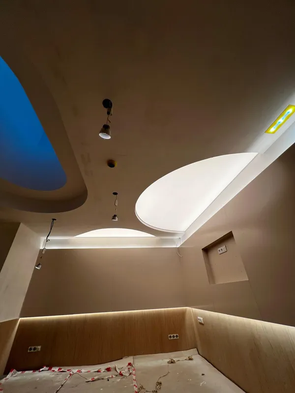 Multi-section stretch ceiling under construction — coloured lighting