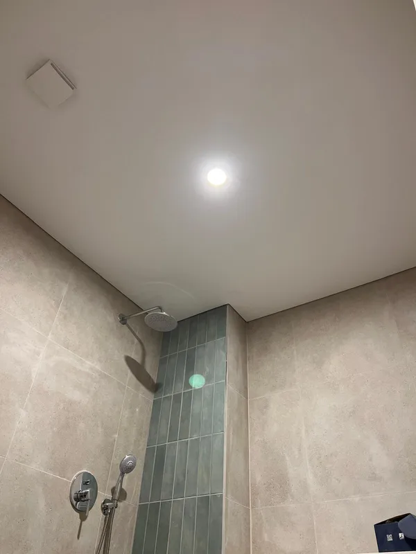 Waterproof stretch ceiling in bathroom with LED shower