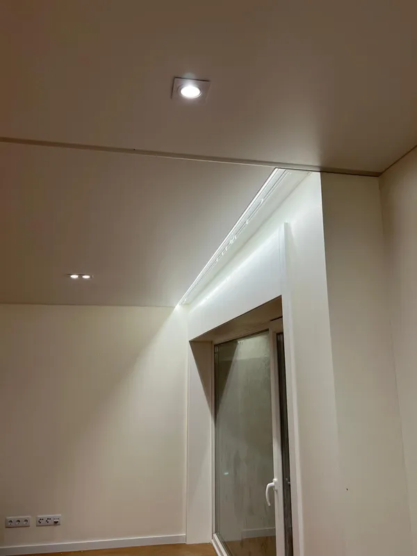 Stretch ceiling with LED above door — residential apartment