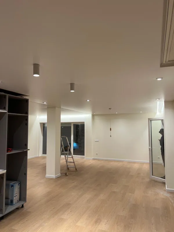 Stretch ceiling in large residential room with LED spotlights
